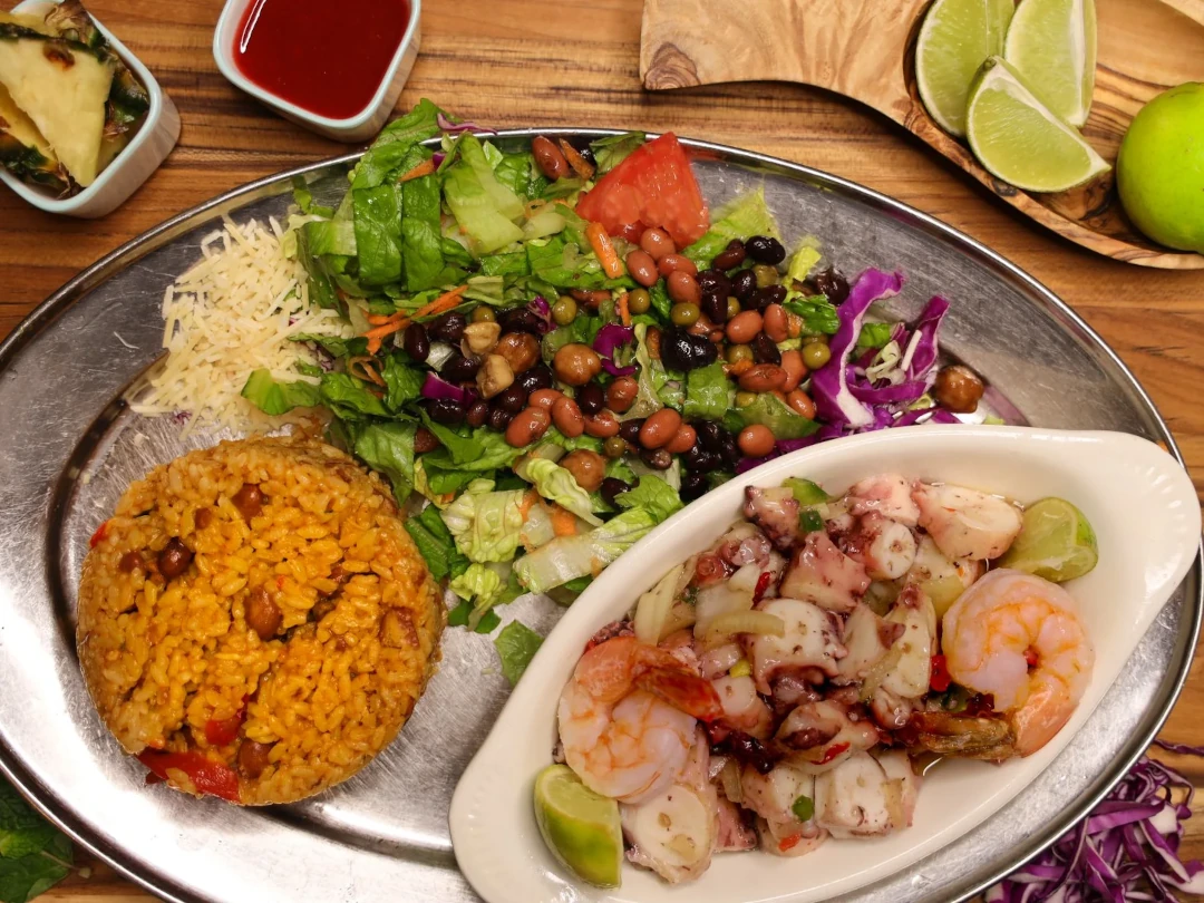A shrimp dish with side salad and rice and beans from La Parilla Restaurant