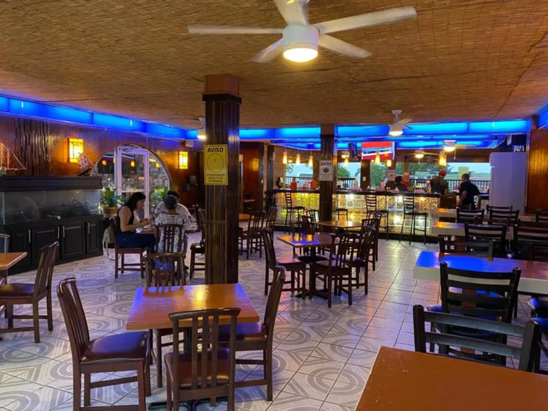 The inside of Tradiciones restaurant has many tables and seating at the bar. 