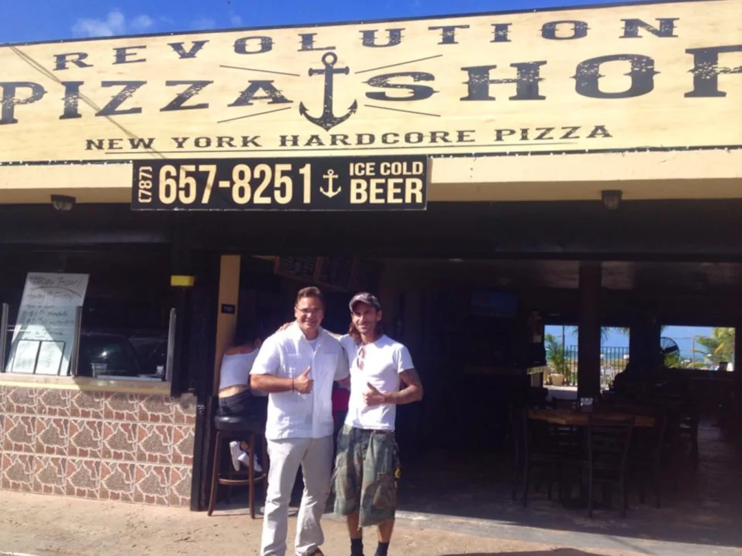 The front of Revolution Pizza Shop, kiosk #34 offering New york style pizza.