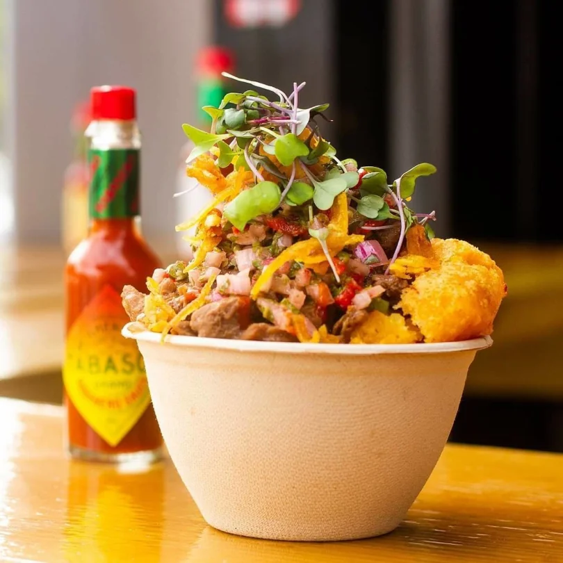 Beef Mofongo topped with fresh pico and sprouts served in an ecofriendly container available at Rellena'o.
