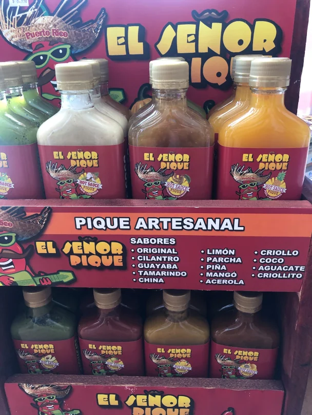 A wide variety of locally made hot sauces available at Emilee's Souvenirs.
