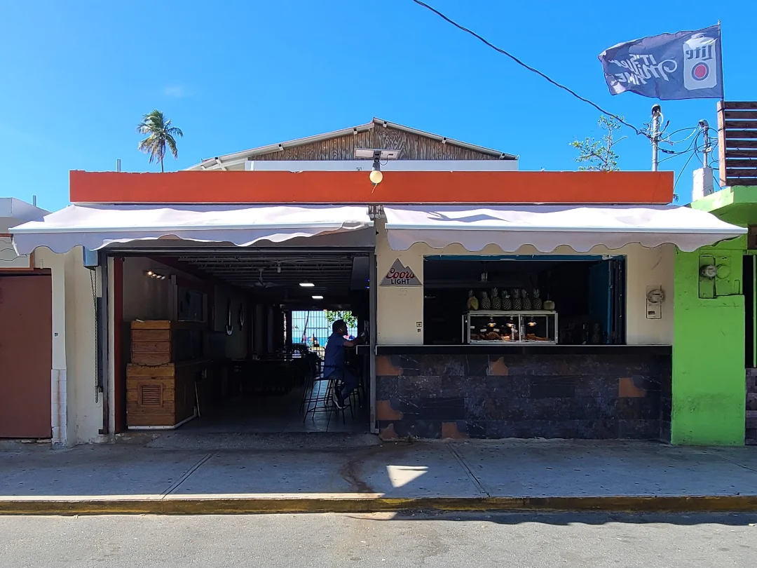 The front of Coconut Sauce Bar and Grill kiosk #55 offering Puerto Rican food.