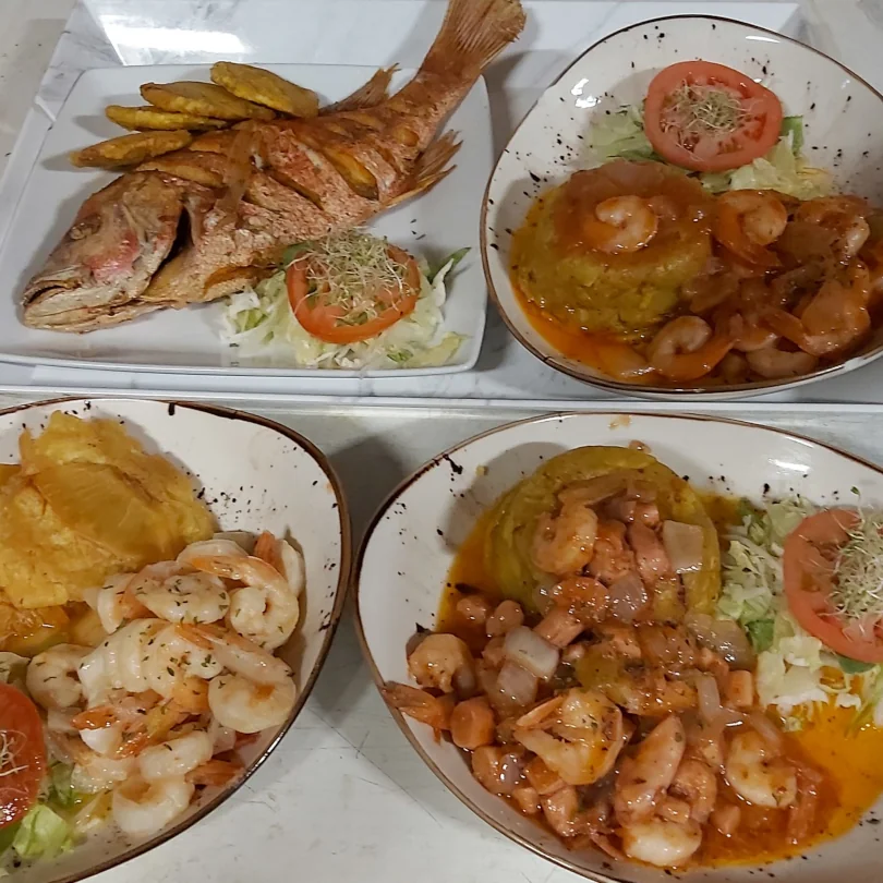 Shrimp mofongo and grilled fish with side salads and fried plantains.